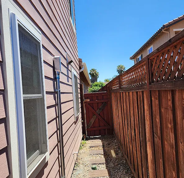 Back passage of the house (towards South) with the gate (facing North).