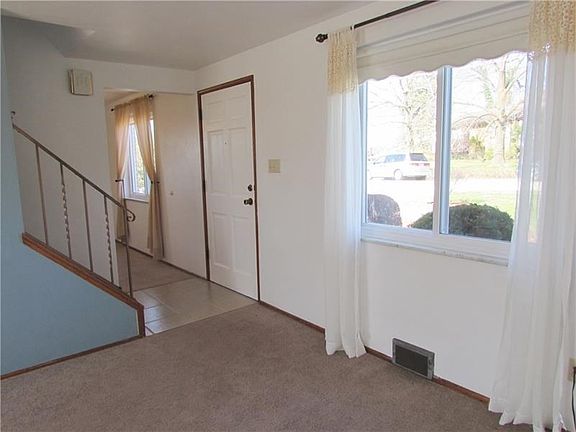 The Welcoming Entry has Ceramic Tile Flooring and is centered between the Living Room & Dining Room
