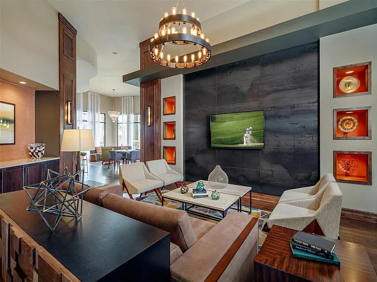 Resident clubhouse entrance with TV lounge area leading into business center and digital cafe