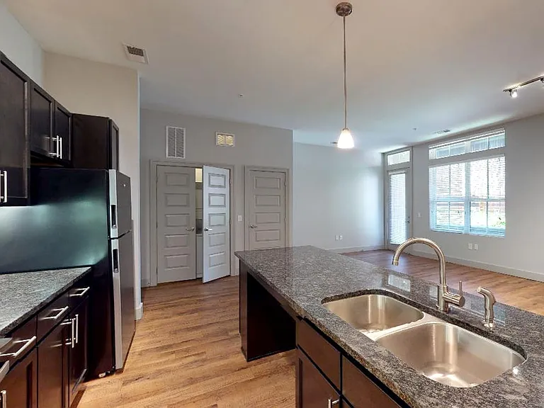 Apartment living room with wood-style flooring and patio or balcony.