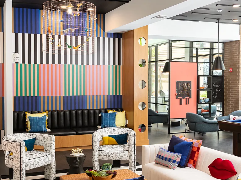Resident Lounge with Bold Design Details, Unique Light Fixture, and Cozy Social Seating