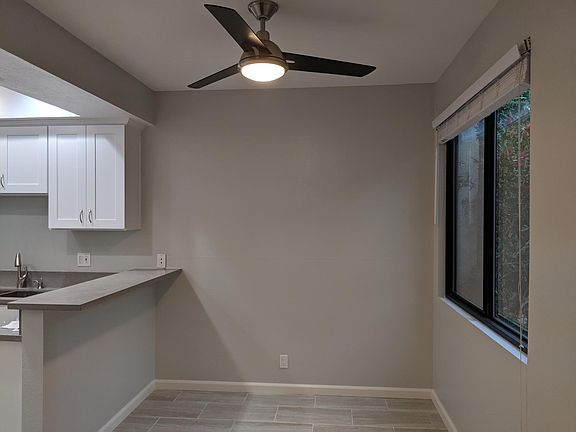 Dining Room: porcelain tile floors, remote controlled fan, double pane glass window, quartz countertop bar.