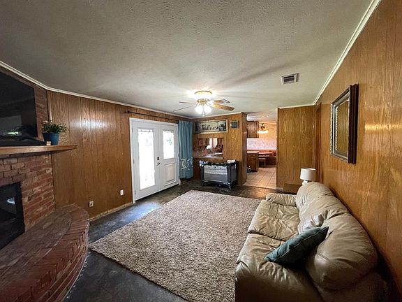 Main living area feature brick fireplace.  Seller offer $1000 flooring allowance.