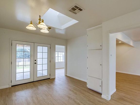 Dining area with French doors and skylight