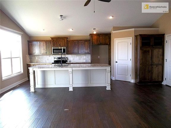 Open Kitchen featuring Large Island, Vaulted Ceiling and Custom Cabinets.