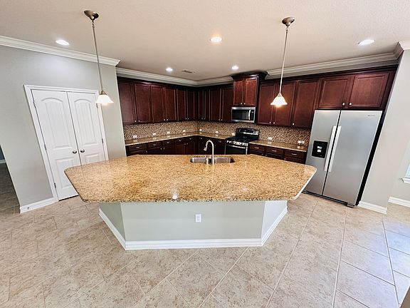 Spacious open kitchen with a large island, perfect for cooking, entertaining, and family gatherings.