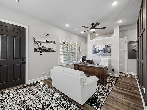 Open office/ sitting area with large windows allowing for fresh air breezes and natural light