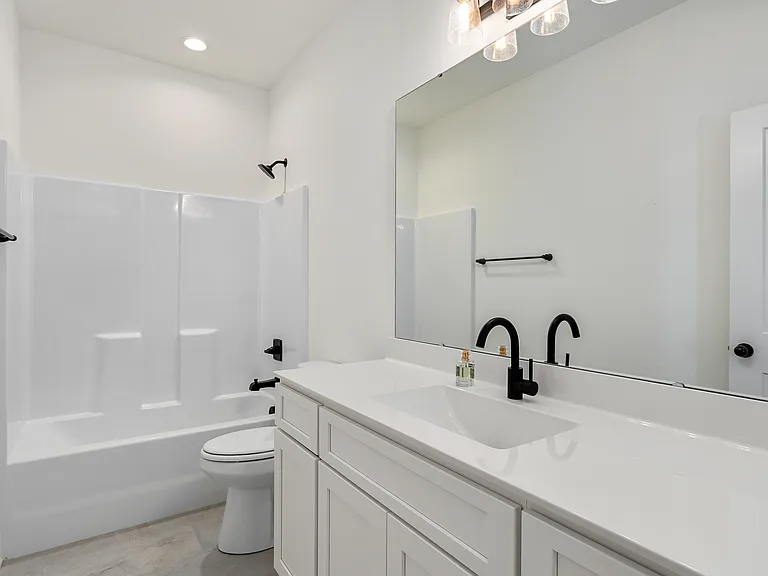 One full bath located at the foremost part of the home with ceramic tile flooring and tub/shower fiberglass unit.