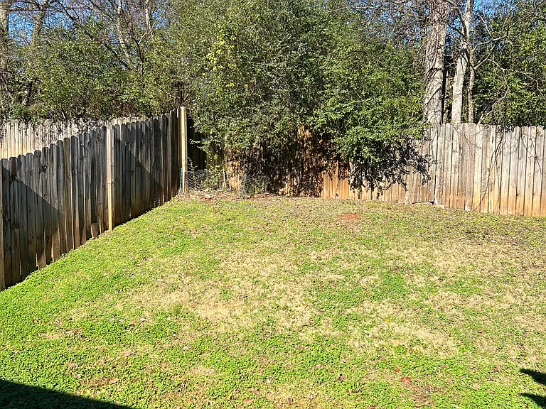 Large fenced backyard.