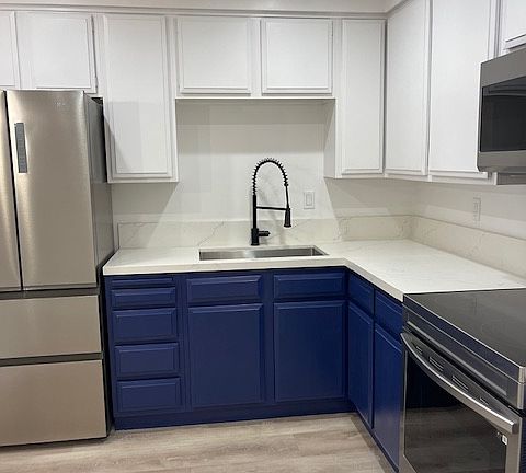 Kitchen includes fridge, stove, microwave