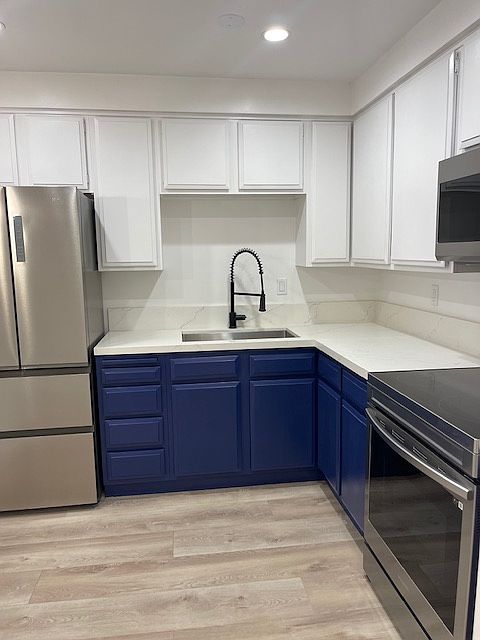 Kitchen includes fridge, stove, microwave