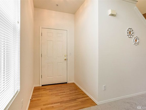 Enter to soaring ceilings, wood floor threshold, fresh interior paint, and light, bright spaces. 