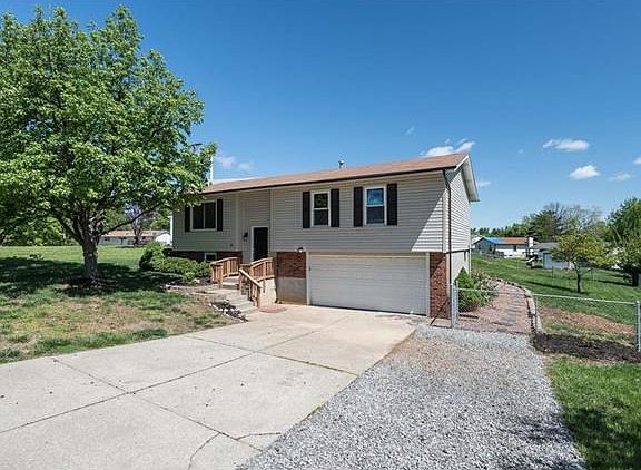 Driveway extended with fresh gravel. Oversized 2 car garage w/ work area and extra storage.
