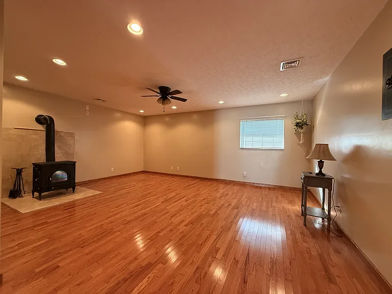 Primary bed with private bath, wood burning stove, hardwoods and walk-in closet