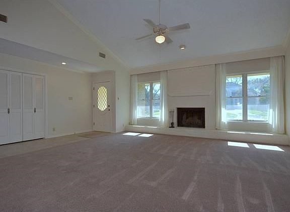 This provides another photo angle of the living space and includes the foyer closet with a set of bifold doors.