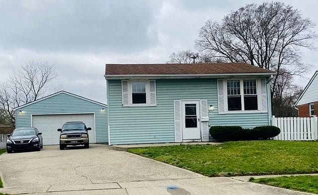 Exterior with large drive way and 2 car garage