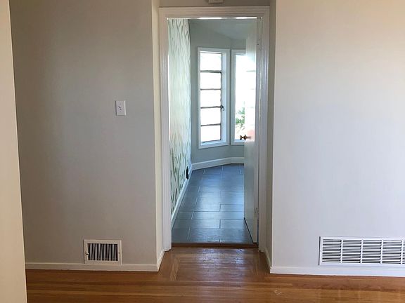 From front door view to eat in kitchen Living area to right Hall to left w three bedrooms and two baths