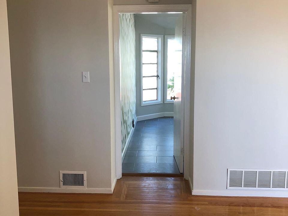 From front door view to eat in kitchen Living area to right Hall to left w three bedrooms and two baths