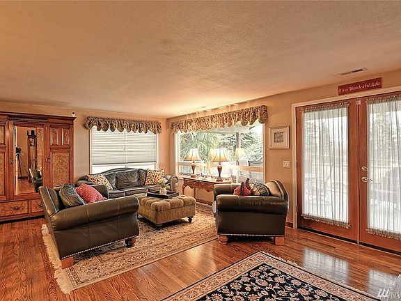 Beautiful hardwood floors in living room. French doors lead to full length entertainer's deck. 