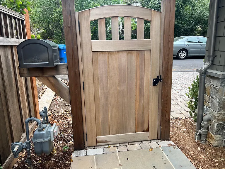 Interior view of the gated entry leading to the front door with private mailbox