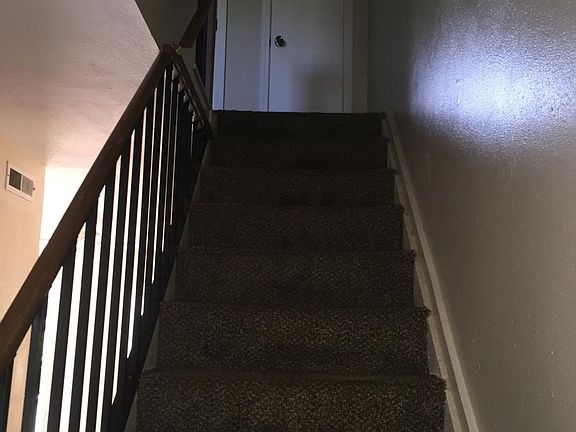 Stairway to bedrooms and bathroom