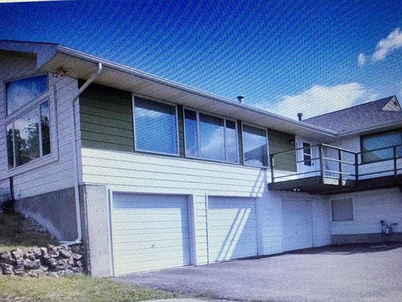 2-car garage with keypad and remote entry. Stairs inside and outside to main floor.