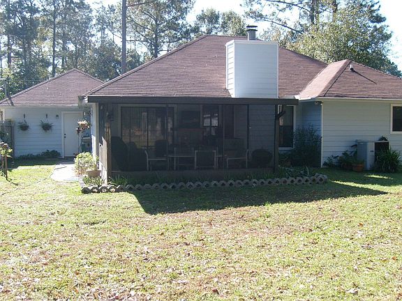 Completely fenced back yard with screened patio