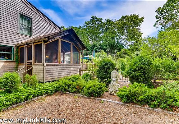 Screened porch off the side of the house.