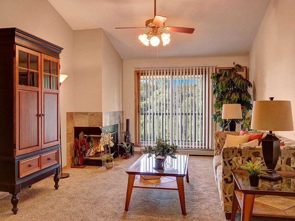 Town Centre Living Room View with Couch, Balcony, and Fireplace