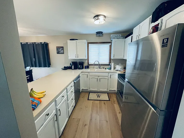 kitchen with updated lighting, updated floors throughout and fresh light and bright painted walls