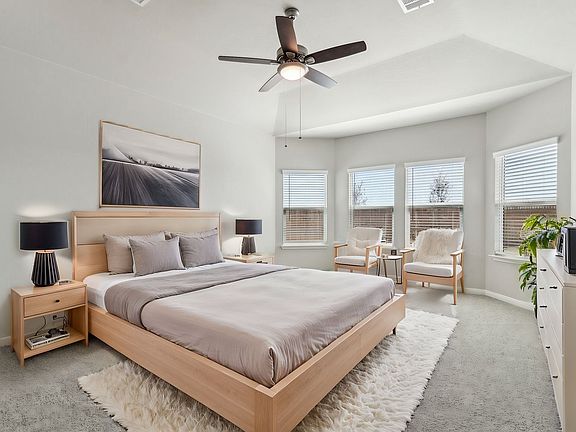 Virtually staged primary suite in the Fitzhugh floorplan at a Meritage Homes community.