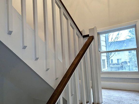 Stairs leading up from foyer to first floor