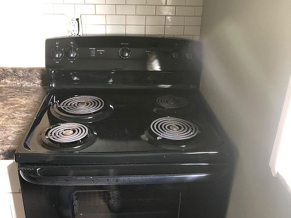 All appliances in excellent working condition and backsplash behind oven for an easy clean area.
