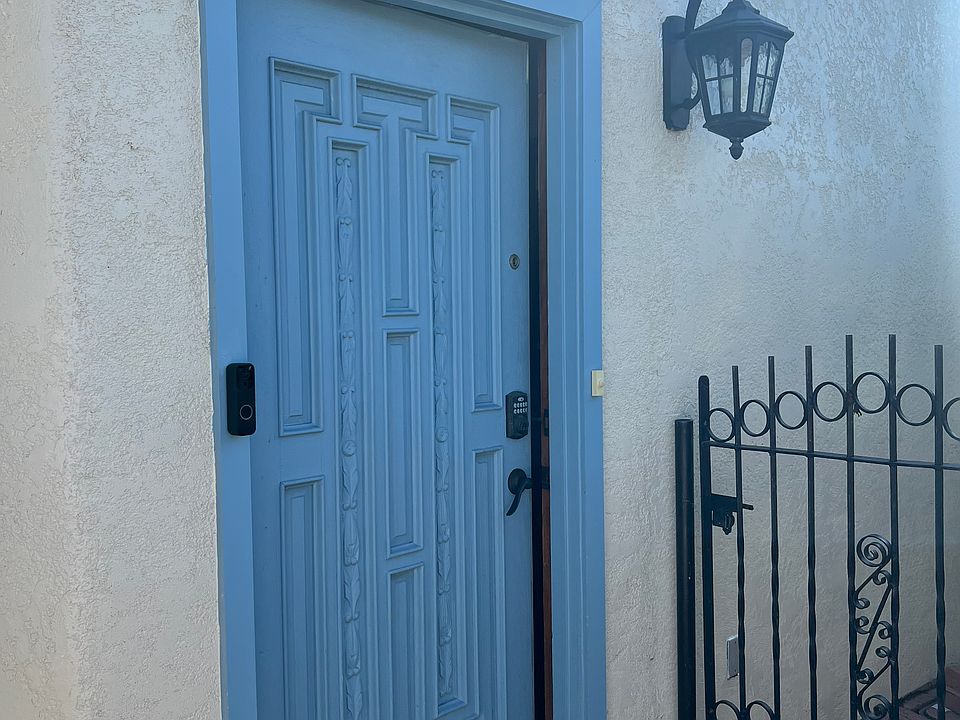 Front door to home with stained glass window above door