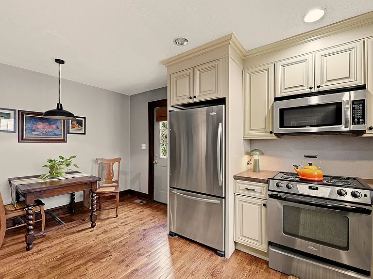 Charming full kitchen with hardwood floors and eat-in area