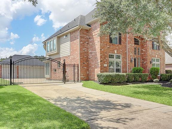 WIDENED DRIVEWAY WITH ELECTRIC SECURITY GATE IS GREAT FOR YOUNG CHILDREN.
