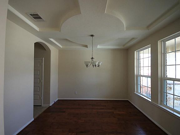 Formal dining has hand scraped engineered wood floors and de