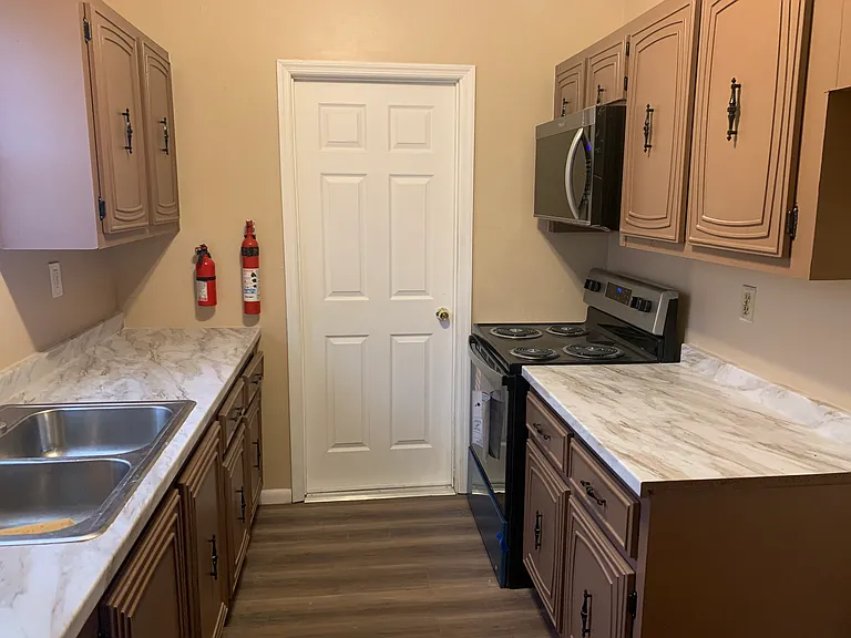 Kitchen with brand new stove and microwave