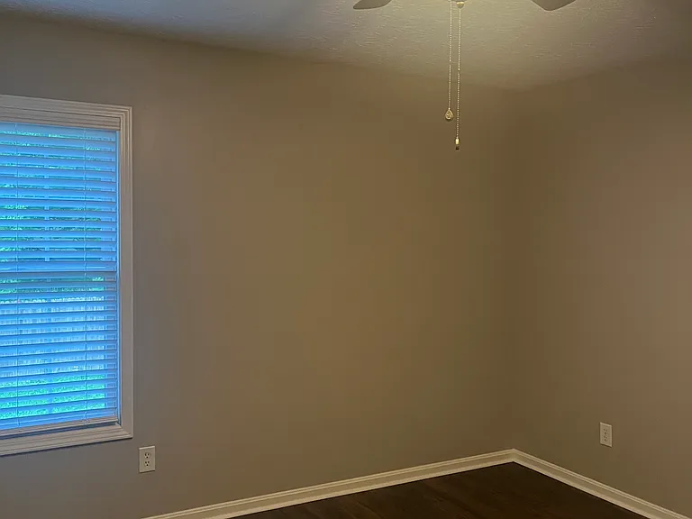 First floor bedroom with NEW flooring, walk in closet and ceiling fan