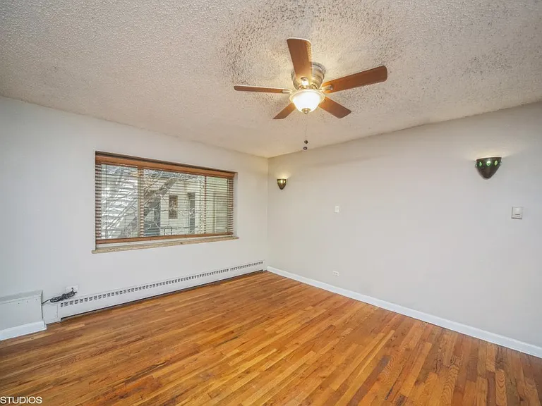 Large windows and rich hardwood flooring