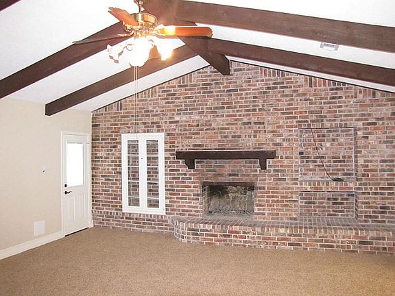 ANOTHER VIEW OF THE FAMILY ROOM WITH VAULTED & BEAMED CEILING. FRESH CARPET WITH UPGRADED PADDING.