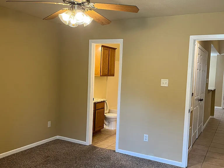 attached bathroom and hall with washer and dryer