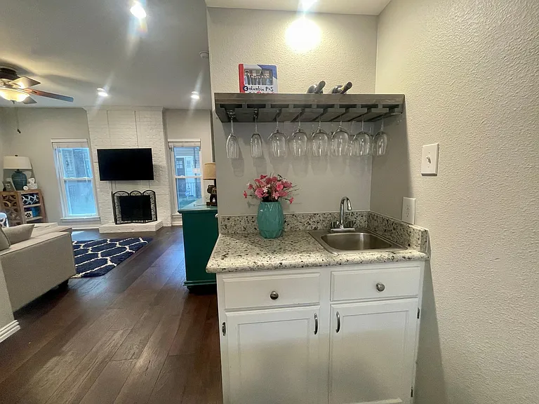 wet bar in the dining room with built in wine glass storage
