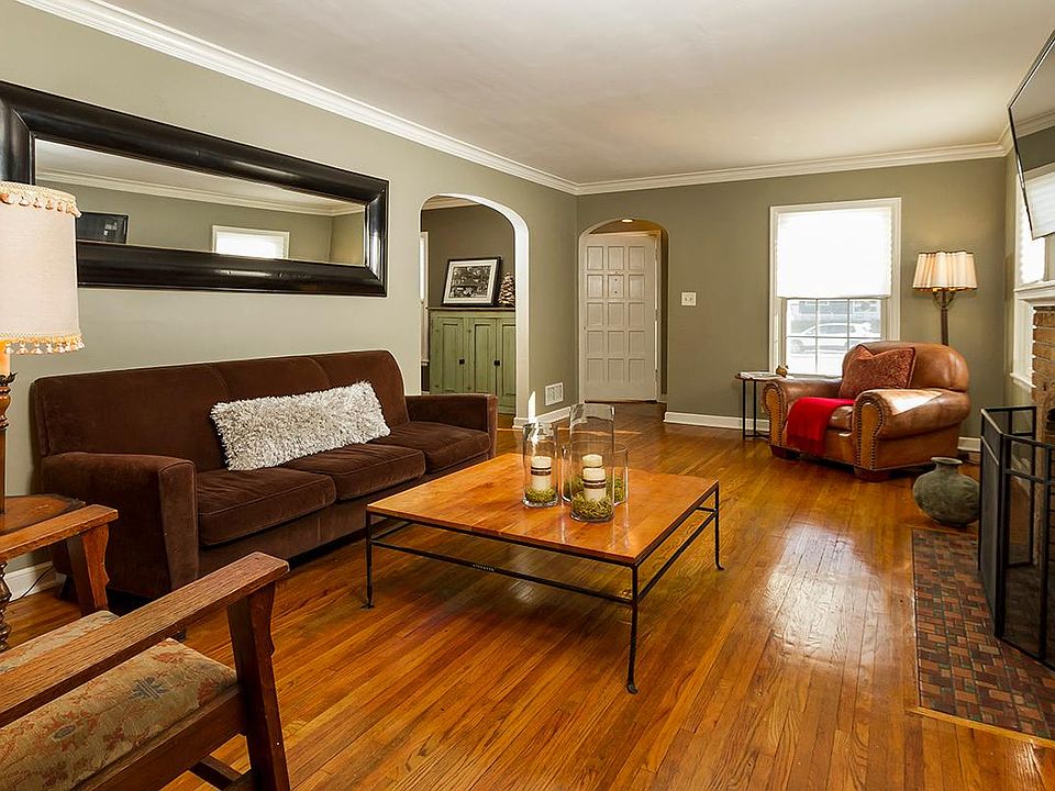 Large sunny living room with wood burning fireplace.