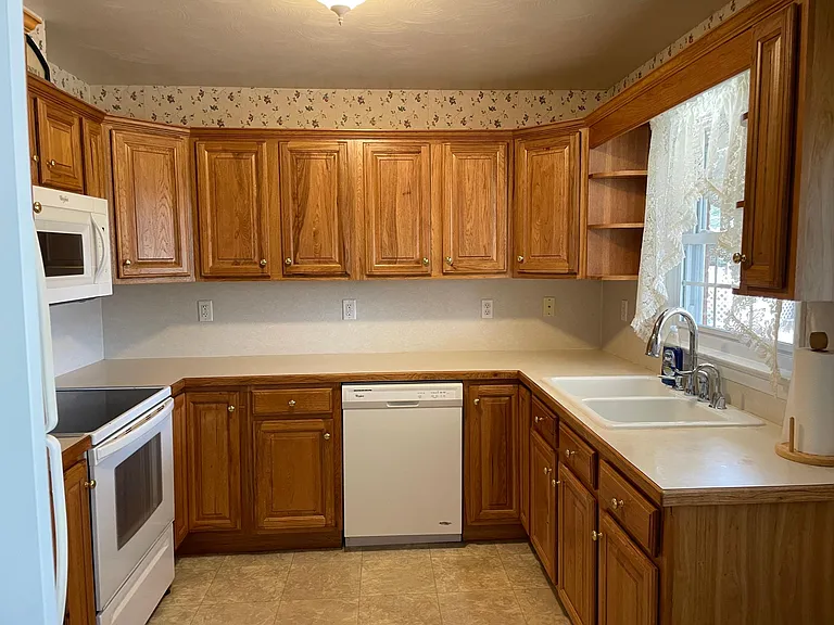 Lots of Oak Cabinets. Kitchen offers garbage disposal, dishwasher, stove, microwave, refrigerator with ice maker.