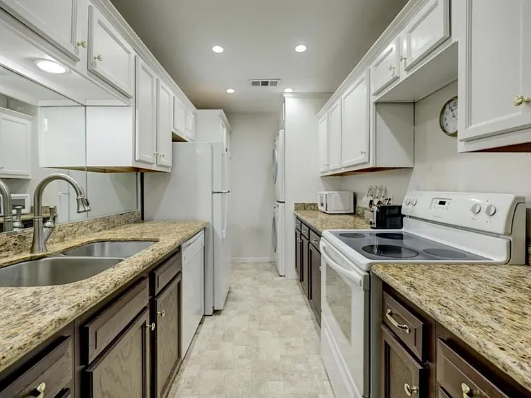 Kitchen with granite countertops, plenty of storage, and washer & dryer.