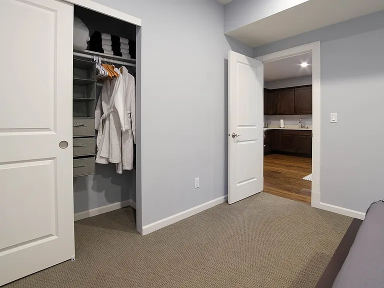 Bedroom, closet with towels and plush robes for hot tub use