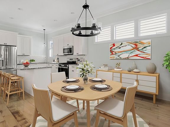 A stylish chandelier hangs over the dining area.