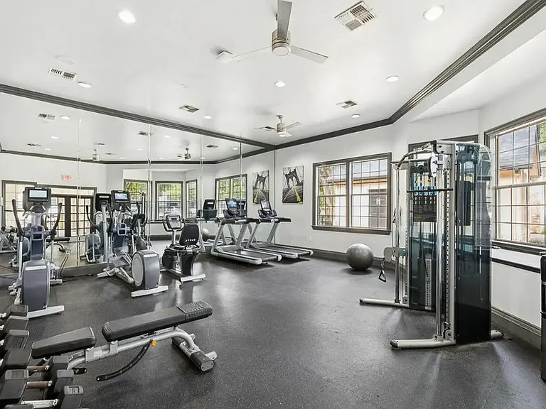 Fully equipped fitness center with free weights, cardio machines and cable machine.