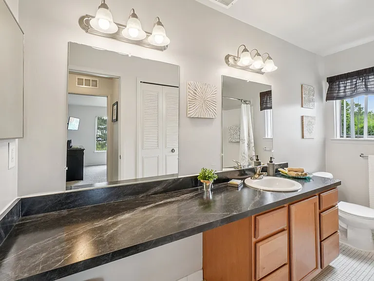 Spacious bathroom with ample storage at Drawbridge Apartments in Harrison Township, MI.